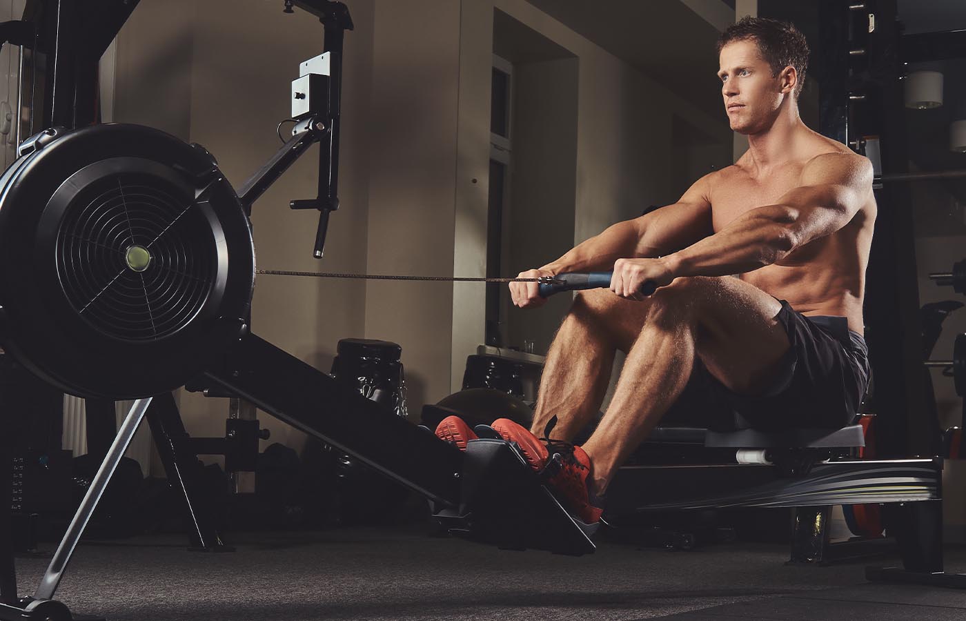 A male athlete demonstrating good form while using a rowing machine
